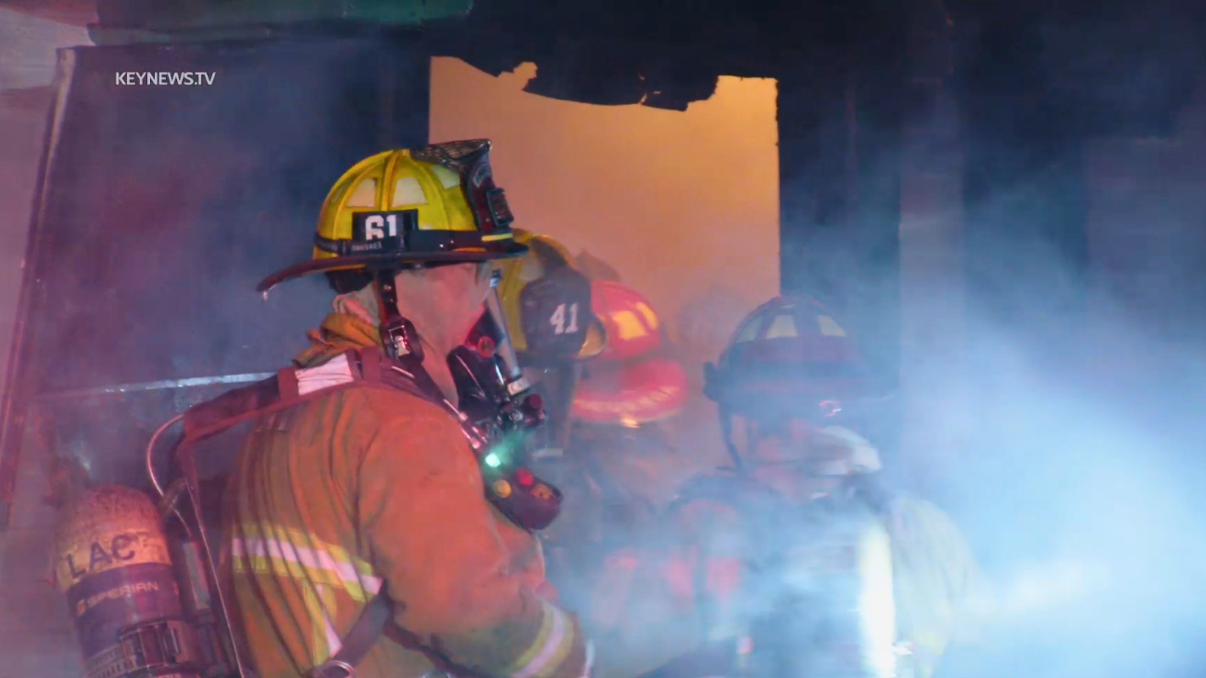 Firefighters enter a burning home in Hollywood on Jan. 17, 2024.